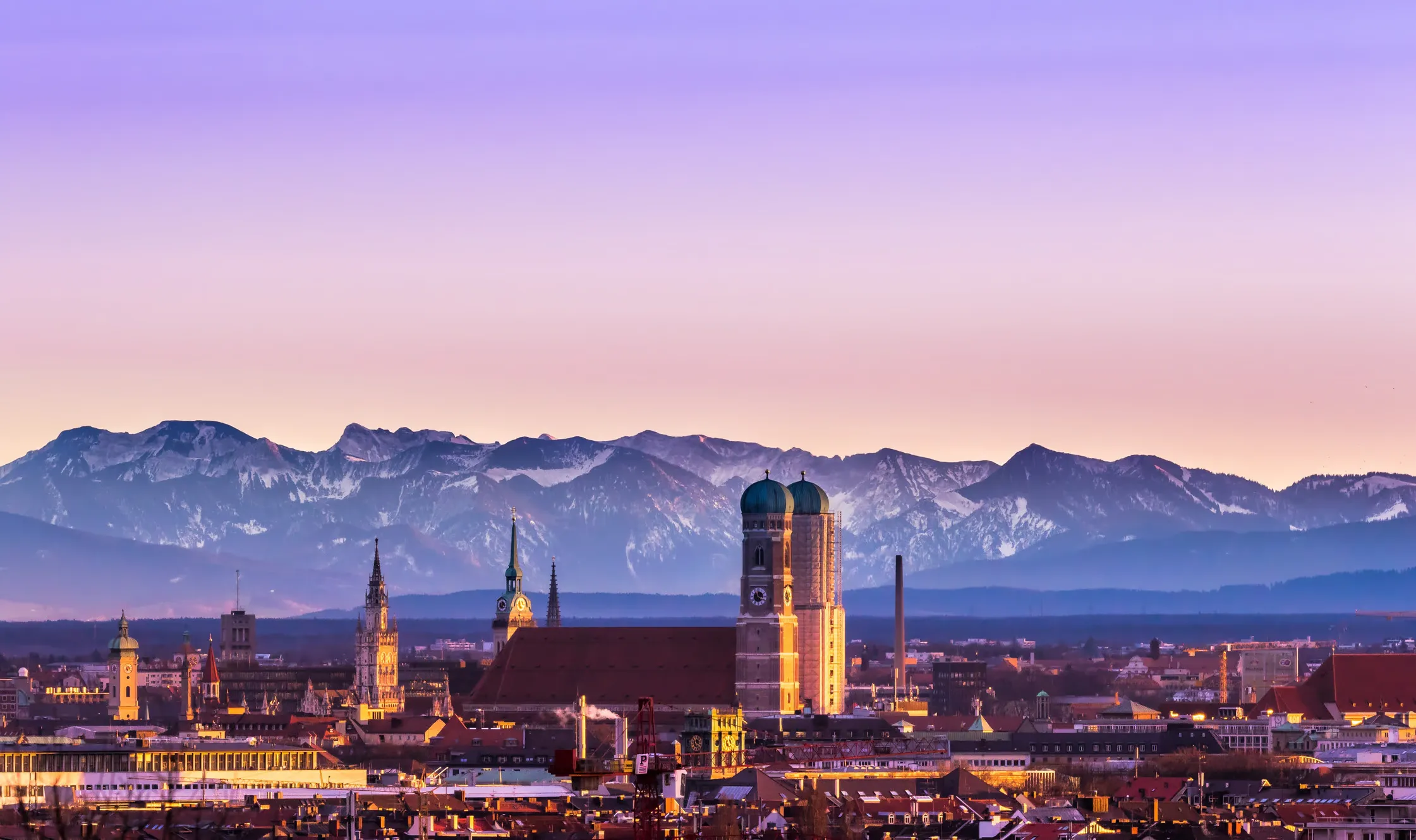 Foreground of Munich skyline and background of the Prealps.